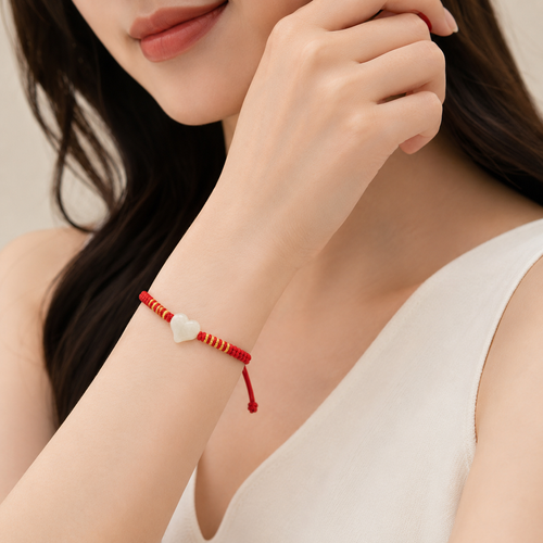Jade heart red string bracelet worn on wrist